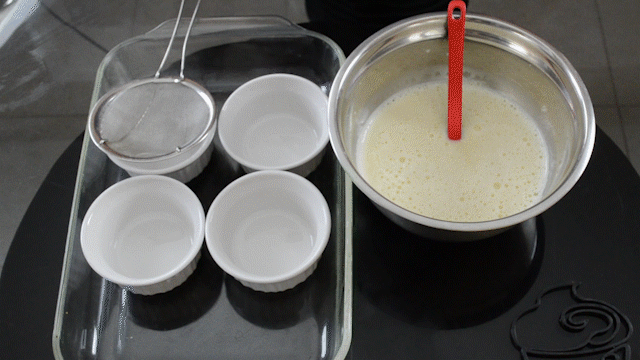 Adding creme brulee mixture to ramekins