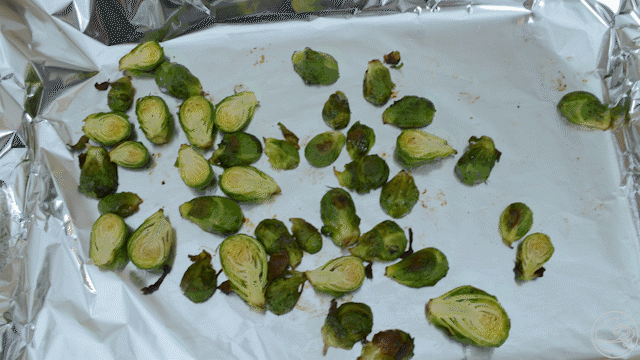 Cooked Brussels Sprouts get put in bowl and glaze drizzled on top